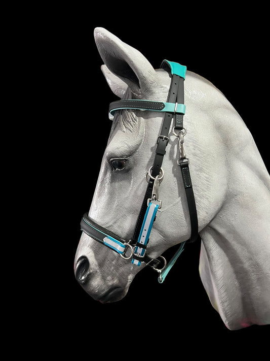 A painted horse head sculpture features a customizable LS Enduro Reflective Bridle by LS Equestrian, with turquoise and silver accents, against a plain black background.